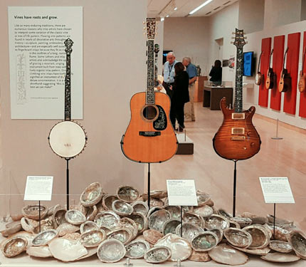 Banjo and guitars displayed with shells