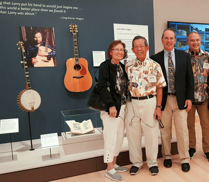 Bill Seymour with visitors in front of Larry Sifel display